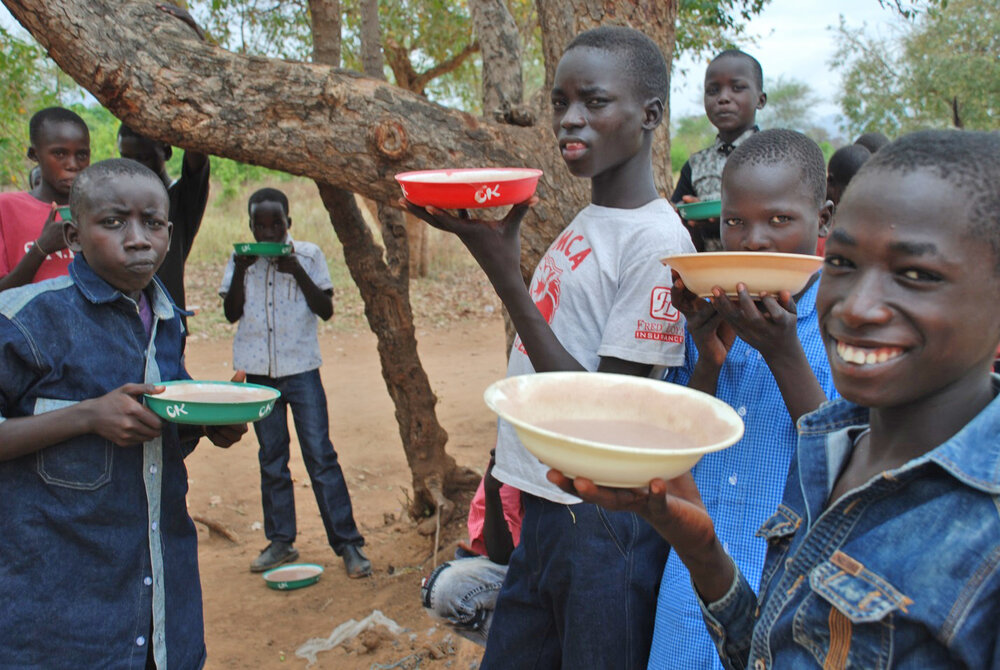 Children enjoy a meal of porridge Hope for South Sudan.&nbsp;Soon the HFSS farm will also be growing the sorghum ingredient used in morning porridge instead of relying on food importation.